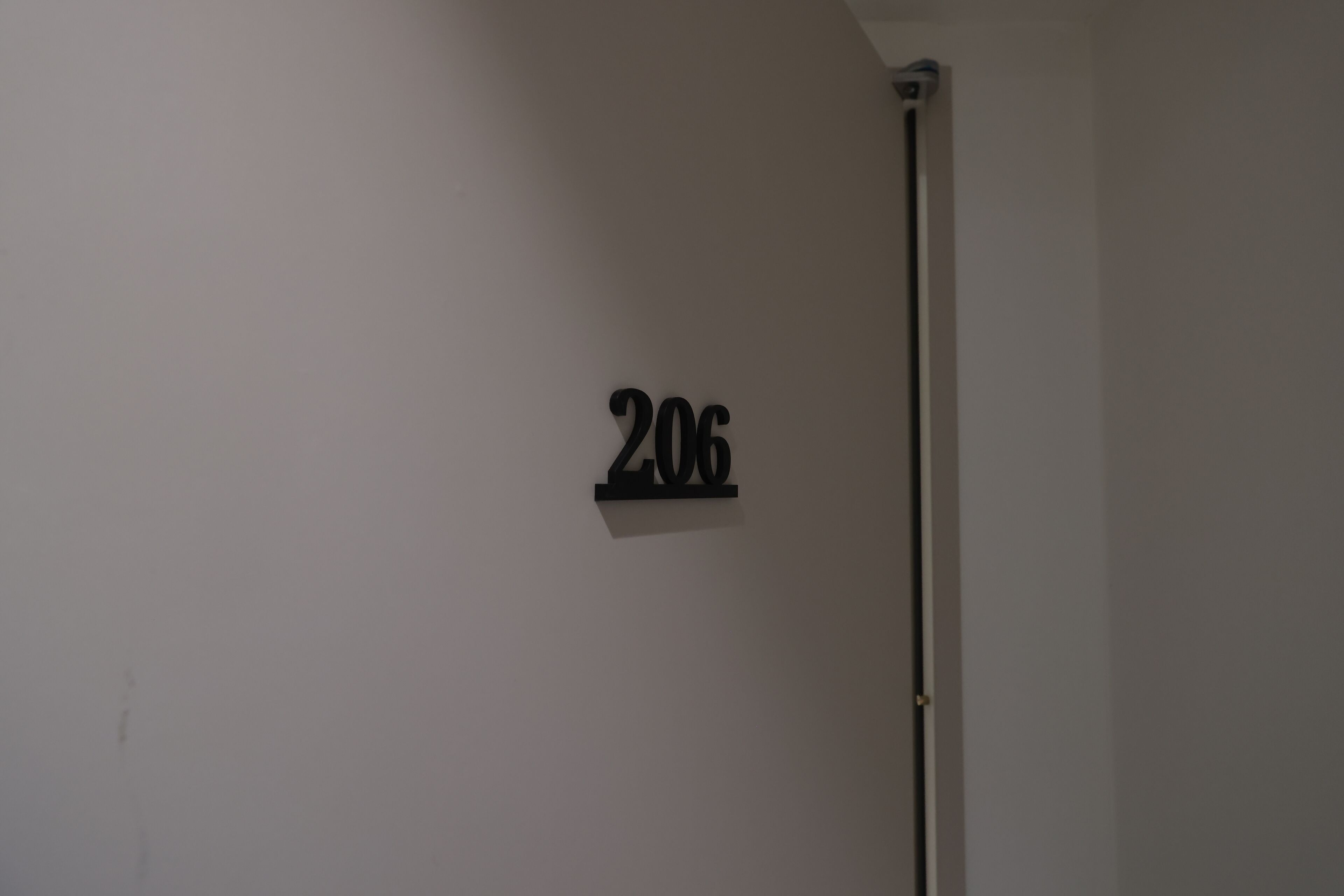 A wall-mounted sign with the number '206'.