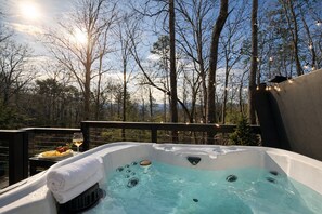 A hot tub with a view of trees and a sunset. - Whiskey N Wine Ridge: Fire Pit, Hot Tub, Ample Parking, pets, near Pigeon Forge (Sevierville)