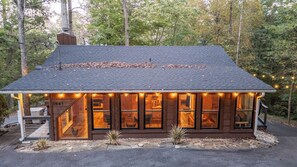 A cabin with a dark roof, large windows, and a number '1645' on the side. - Whiskey N Wine Ridge: Fire Pit, Hot Tub, Ample Parking, pets, near Pigeon Forge (Sevierville)