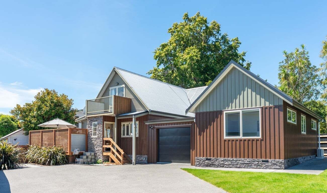 A two-story house with a garage, a staircase, and a covered porch.