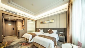 A hotel room with two beds, a desk, a chair, a small table, and a wall-mounted TV. - ShenZhen Romanjoy International Hotel (Shenzhen)