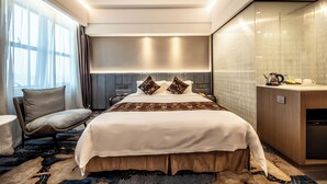 A modern hotel room with a large bed, bedside tables, a desk, and a built-in wardrobe. - ShenZhen Romanjoy International Hotel (Shenzhen)