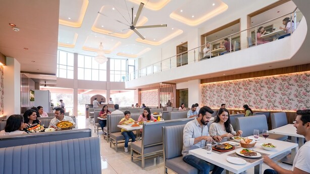 A modern restaurant with high ceilings, recessed lighting, and a central ceiling fan. - Fabhotel Prime Shree Palace (Palghar)