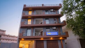 A multi-story building with a sign for 'fabHOTELS' indicating it is a hotel. - Fabhotel Sky Sector 76 (Gurugram)