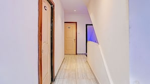 A narrow hallway with a door labeled '101' and a door labeled '106'. - Fabhotel Orange Residency (Mumbai)