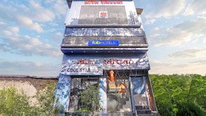 A hotel with a signboard, a name in a non-English script, and a logo for 'fabHOTELS'. - Fabhotel Orange Residency (Mumbai)