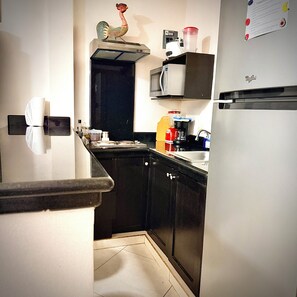 A kitchen with a microwave, coffee maker, and refrigerator. - Apartment C (Zona Romantica) (Puerto Vallarta)