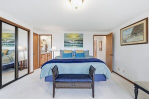 A bedroom with a bed, a chair, a desk, and a mirror. - Cliffside Retreat Near Beach Access (Newport)