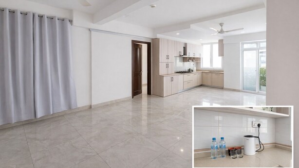Un vaste espace de vie comprenant une cuisine, un ventilateur de plafond et une porte coulissante.