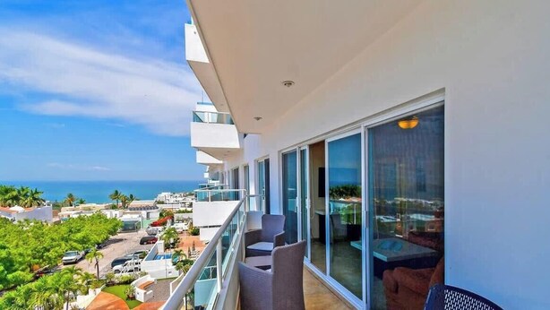 A balcony with a view of the ocean, a pool area, and a dining area with outdoor seating. - Oceanview Balcony, BBQ Lounge, Near Malecon (La Paz)