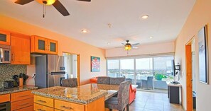 A modern kitchen with granite countertops, stainless steel appliances, and a dining area with a large island. - Oceanview Balcony, BBQ Lounge, Near Malecon (La Paz)