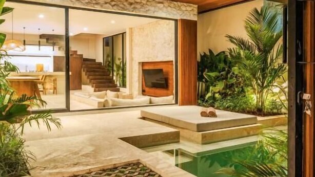 A modern house with a pool, outdoor seating, and a staircase leading to an upper level. - La Finca Villa Bingin, Uluwatu by Sandara (Pecatu)