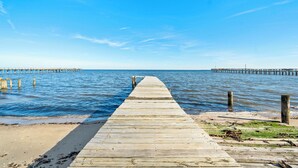 A wooden pier extending into calm water, with a clear sky above. - Fabulous 5-bedroom house with AC in charming Port Republic. Walk to water/trail (Port Republic)