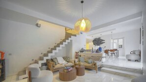 A modern living room with a staircase, a sofa set, and a dining area. - 13491130 FRGK French Riviera Villa with Private Pool AC (Cannes)