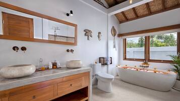 Separate bathtub and shower, towels, soap, shampoo