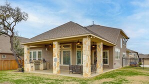 A house with a covered patio, stone pillars, and a grill area. - 2 Mi to TPC San Antonio: Group Getaway w/ Theater! (San Antonio)
