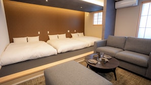 A hotel room with a bed, sofa, and a small table with a glass and a cup. - THE NINE STATES HOTEL TOJINMACHI (Fukuoka)