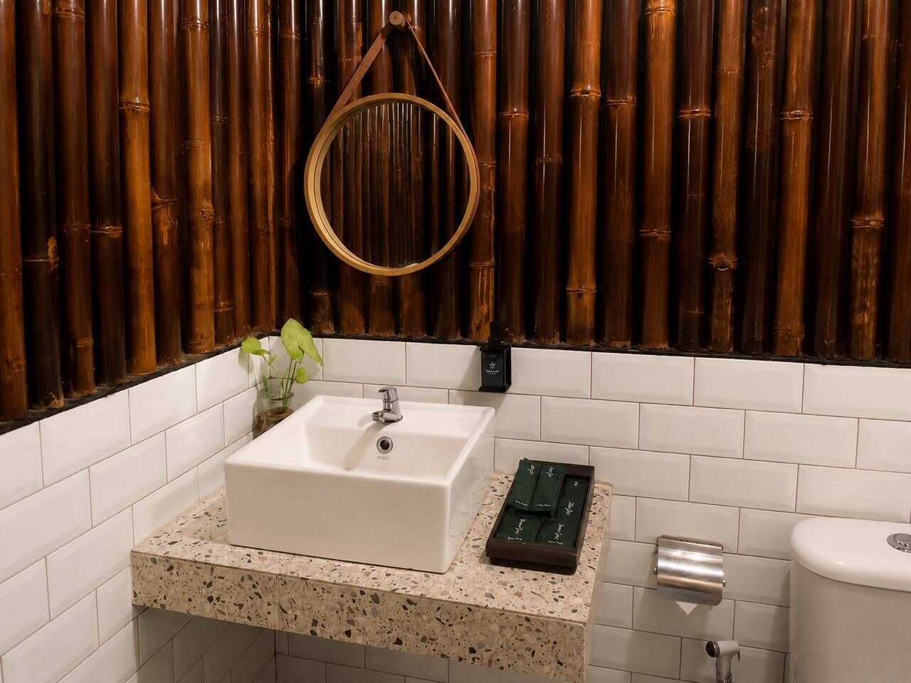 A bathroom with a white sink, a mirror, and a toilet.