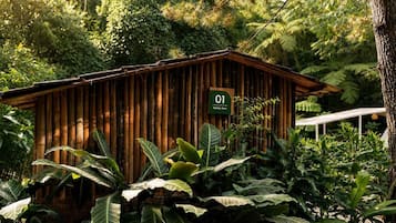 A bamboo structure labeled '01 Family Tent' surrounded by lush greenery.