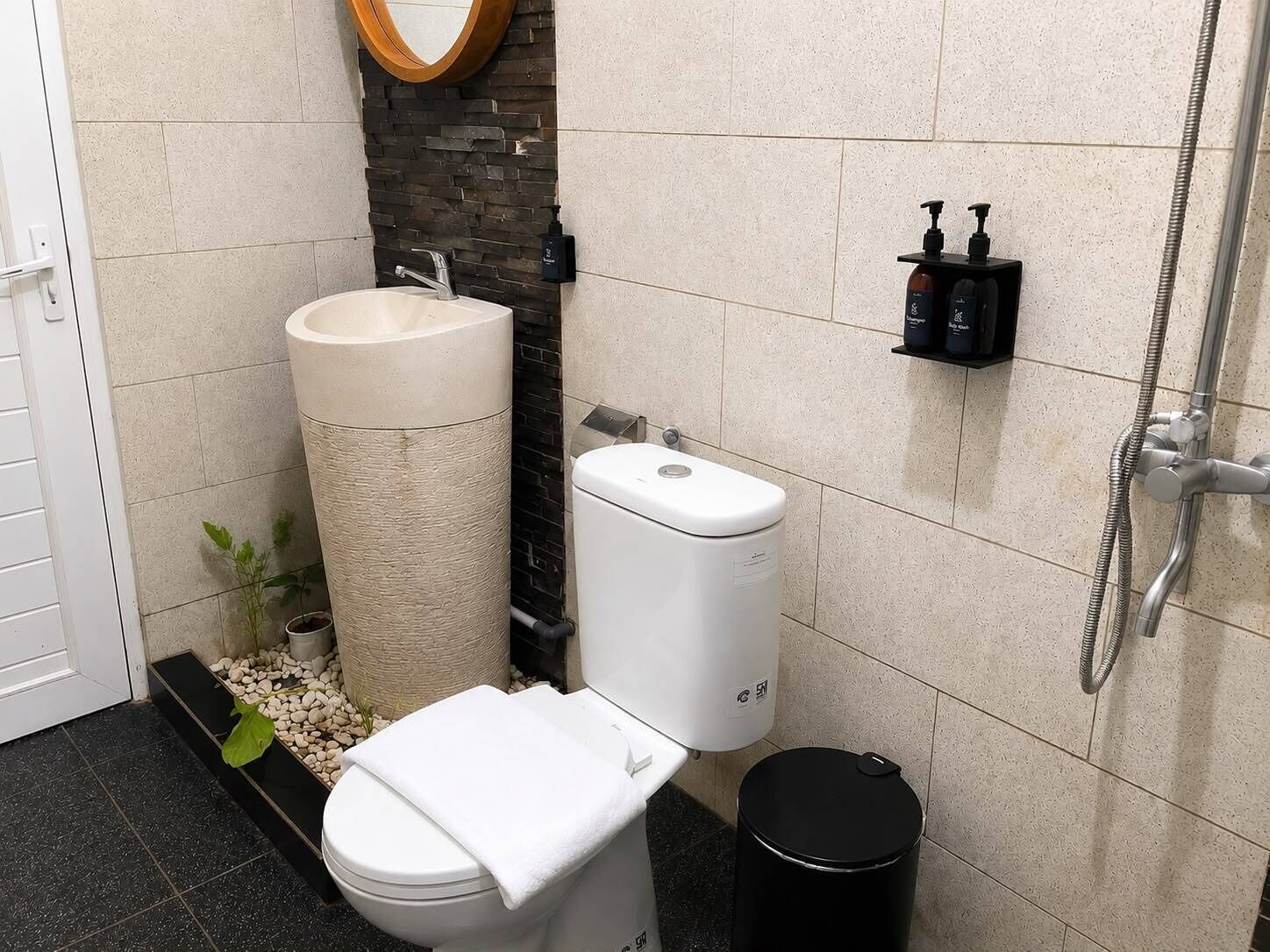 A bathroom with a toilet, sink, and shower.