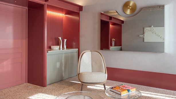 A modern interior with a red accent wall, a glass table, a chair, and a book on the table. -  Elizabeth Unique Venice a Member of Design Hotels (Venice)