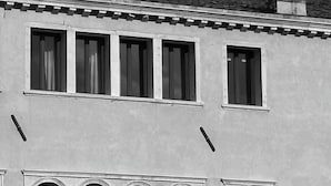 A building with a balcony, arched windows, and a chimney. -  Elizabeth Unique Venice a Member of Design Hotels (Venice)