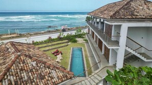 A coastal hotel with a swimming pool, a view of the ocean, and a terraced garden. - UNU Boutique Hotel (Ahangama)