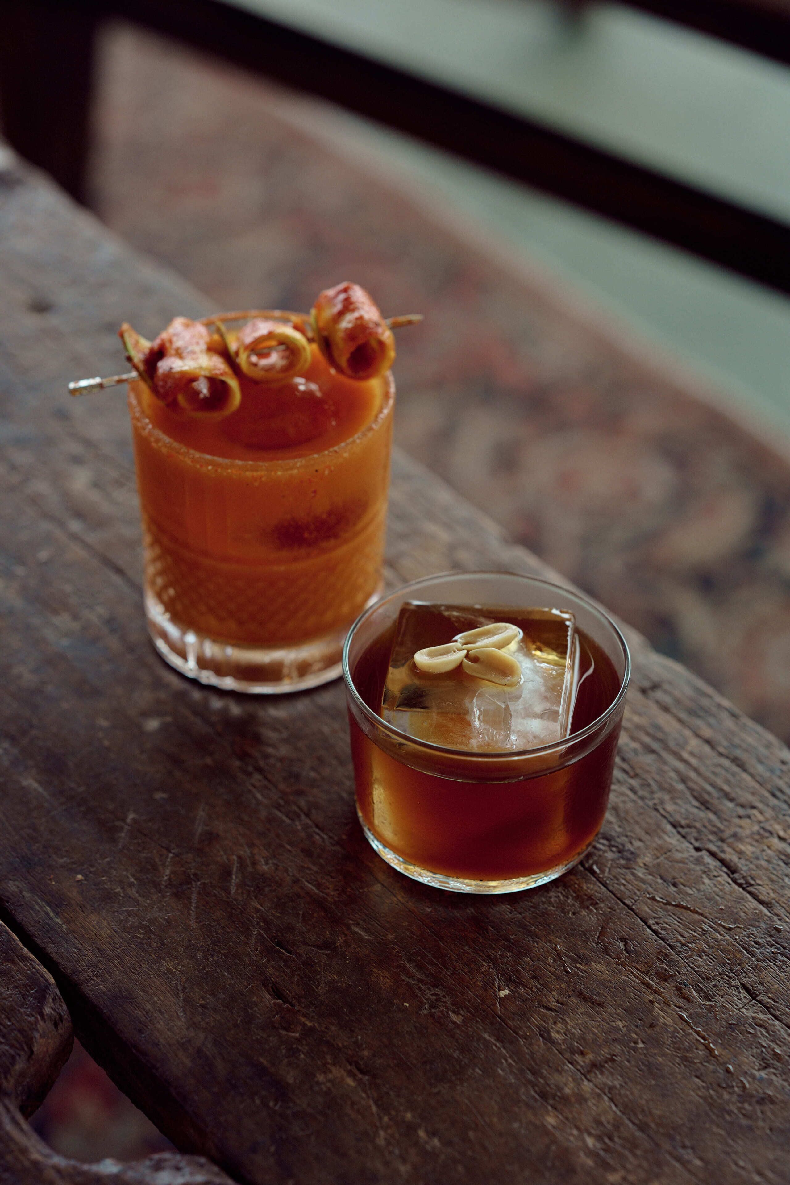 Two drinks on a wooden surface.