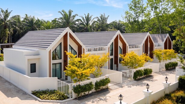 A modern building with a flat roof, large windows, and a white exterior. - Dinnano (Khlong Thom)