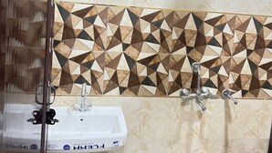 A bathroom with a sink, mirror, and shower.