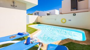 A swimming pool with lounge chairs and a lifebuoy. - Villa Paula in Costa Teguise (Teguise)