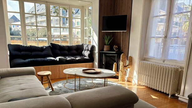 En stue med sofa, sofabord og fjernsyn.