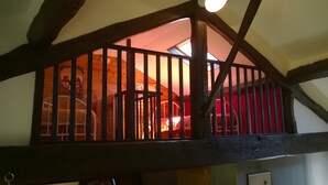 A wooden staircase with a view of a room below. - Le Gîte D'Au: Heated Pool, Spa & Fishing Pond (Saint-Amand-Magnazeix)
