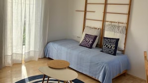 A bedroom with a bed, a small round table, and a window with sheer curtains. - Authentic Istrian Apartments Villa Zambratija (Umag)