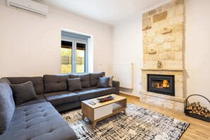 TV, fireplace - AG Stone Home - Idyllic Beachside Villa in Isthmia (Isthmia)