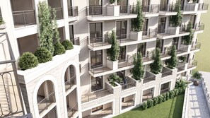 A multi-story building with balconies, large windows, and greenery. - Hotel Aranka (Budva)