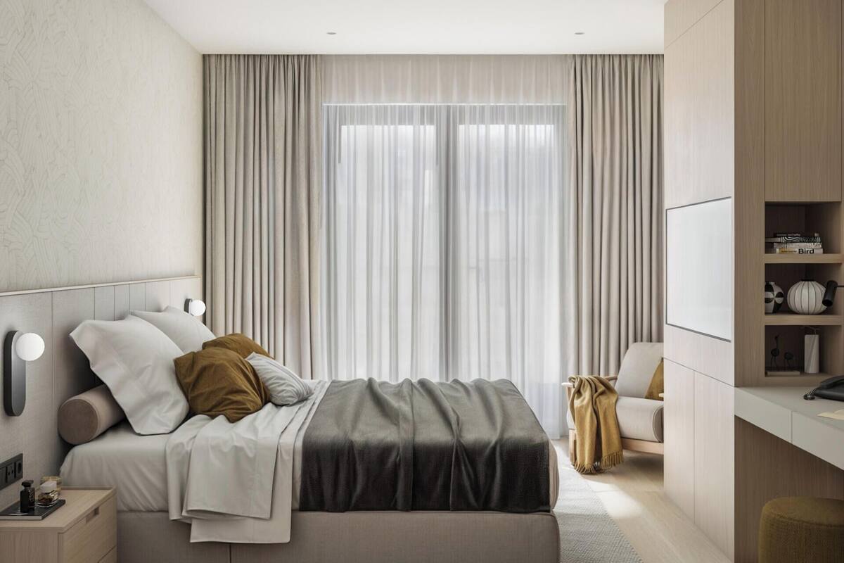 A modern bedroom with a bed, bedside tables, a desk, and a wardrobe.