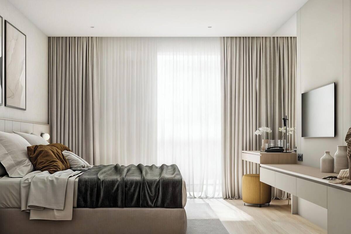 A modern bedroom with a bed, bedside table, lamp, and a desk with a mirror.