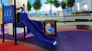 A playground with a slide and climbing structures. - Titiwangsa Core at TR Residence by HCK (Kuala Lumpur)