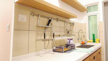 A kitchen with a built-in oven, a sink, and a window above the counter.