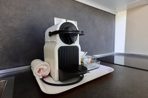 A Nespresso coffee machine on a countertop with a rolled towel and a glass container. - NAUTILIA  203 - Premium Luxe - Balcony - 2 people (AGDE)