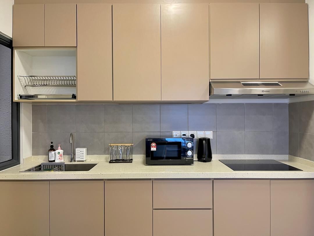 A kitchenette with a microwave, a coffee maker, and a sink.