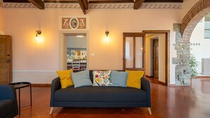 A living room with a sofa, a coffee table, and a patterned rug.