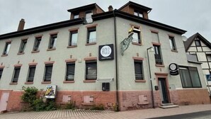 A multi-story building with a sign indicating it is a hotel. - RICLS Apartmenthaus - BRIGHT Collection (Wurmberg)