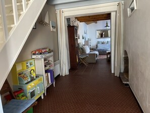 A room with a staircase, a play area with toys, a bed, and a chair. - House near sea and woods - 6 guests (La Guérinière)