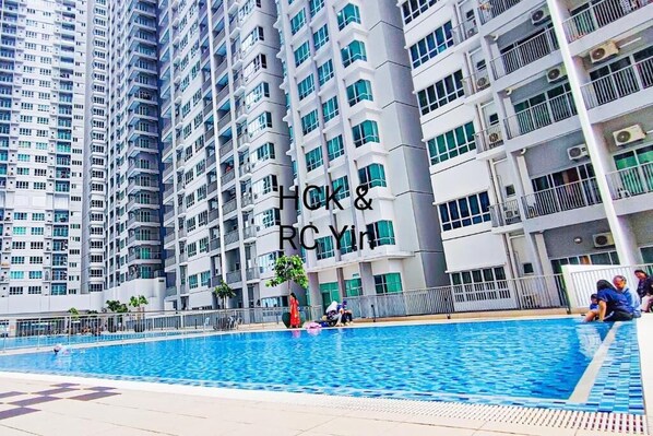 Un immeuble résidentiel de grande hauteur doté d’une piscine et de balcons.