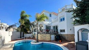A residential property with a swimming pool, stone walls, and a balcony with outdoor furniture. - R1387 Casa Udo by CG Nerja Rentals (Nerja)