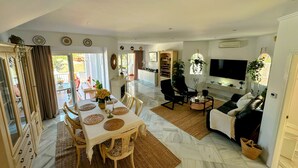 A spacious living area with a dining table, chairs, a sofa, and a TV. - R1387 Casa Udo by CG Nerja Rentals (Nerja)