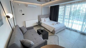 Une chambre d’hôtel moderne avec un lit, un canapé et une petite table.
