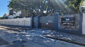 A gated entrance to a property labeled 'Madiba Bay Guest House' with a sign indicating 'No Parking.' - Madiba Bay Guesthouse (Gqeberha)